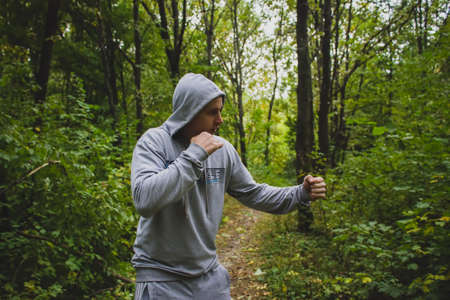 the young man in the woods,training in Boxingの写真素材