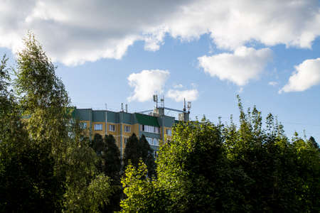 Orange house on a background of trees and sky