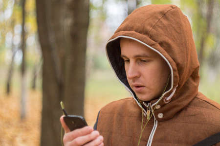 Young man listening to music on smartphone on the natureの写真素材