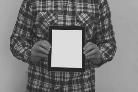 young man holding tablet with white screenの写真素材