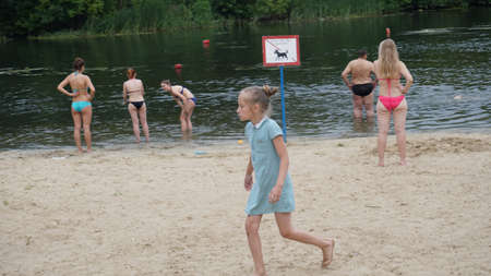 guys relax on the beach standing on the shore.のeditorial素材