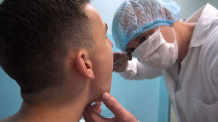 the young guy on reception at the dentist. Dental treatment.の写真素材