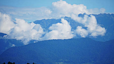 Mountain peak range landscape. Green mountain range view. Mountain peak blue sky white clouds...