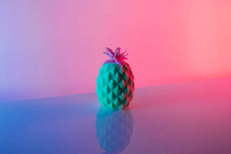 Glass against neon iridescent pink and blue colors. Minimal  party life concept.の写真素材