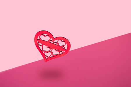 Valentine's day pink background. Minimal concept with wooden hearts. Mother day.