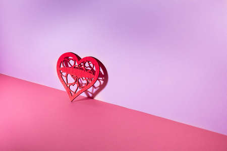 Valentine's day pink background. Minimal concept with wooden hearts. Mother day.の写真素材