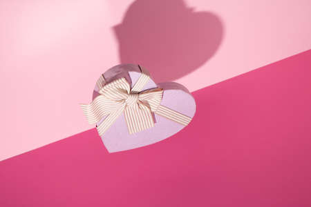 Valentine's day pink background. Minimal concept with wooden hearts. Mother day.の写真素材