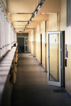 Long empty corridor with windows allowing in daylight receding into the distanceのeditorial素材