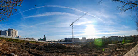 Big hole, crane and mud on deserted construction site spilled