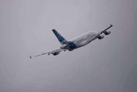 Airbus A380 is flying off in the cloudy skyのeditorial素材