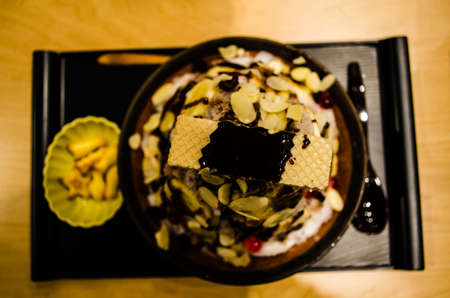 A Dessert made milk in ice form, shatter to snow and take biscuit jelly or anything on it  Yummy  の写真素材