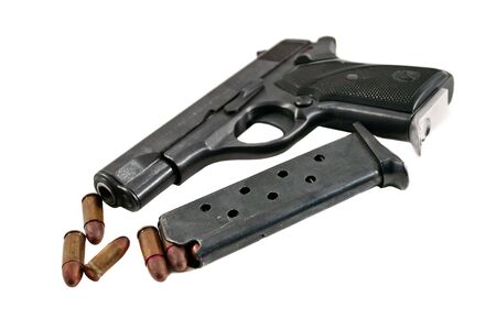 Pistol with bullets isolated on white