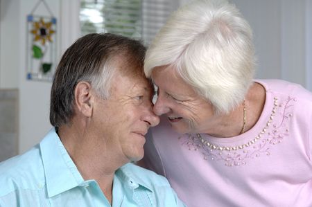 Senior romantic couple shares some intimate moments at their home.の写真素材