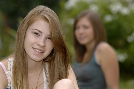 Teenage girls spend some time outside in the garden.の写真素材