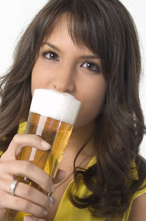 Pretty girl drinking beer from the glassの写真素材