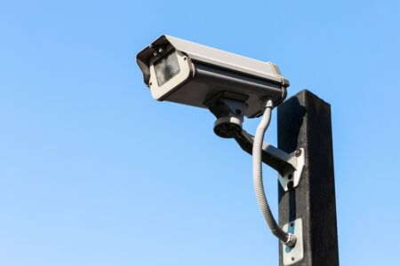 Old closed circuit camera on blue sky backgroundの写真素材