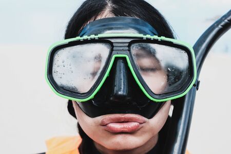 Close-up Asian woman wearing a black half-face snorkels after diving in the seaの写真素材