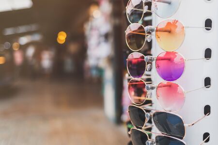 Colorful sunglasses Hung in a row in front of the store in the marketの写真素材
