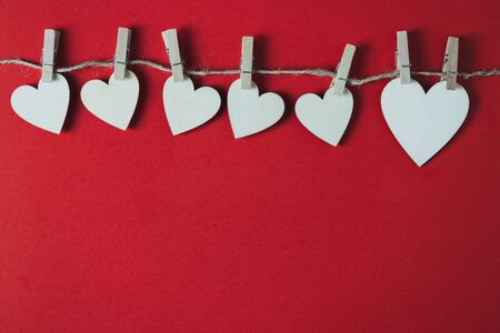 White wooden heart on a red background Top view, valentine's day, themeの写真素材