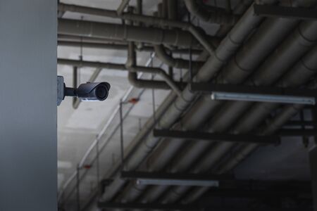 Close up of CCTV in the parking building with the water pipe system backgroundの写真素材