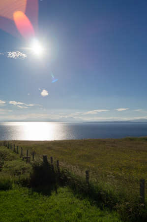 A sun flare at sunrise on the isle of Skye