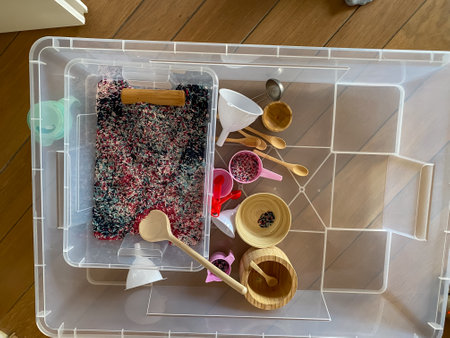 A sensory bin filled with play rice after playの写真素材