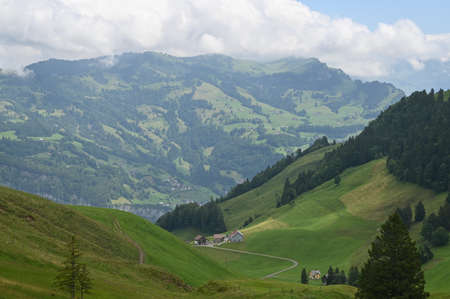 Beautiful landscape with Alps view across green fields in the Switzerland.の写真素材
