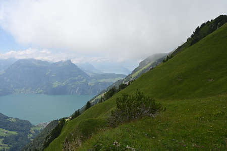 Landscape with lakes in the background and green hills peaks with pine-trees.の写真素材