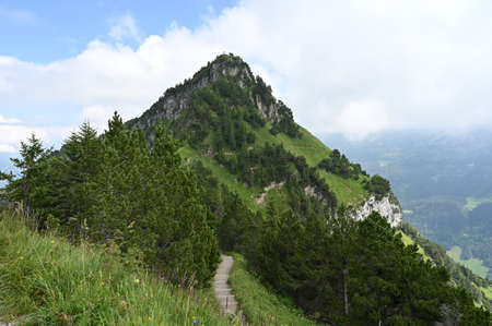 Summit Cross on the mountain peak during a hiking trail in Switzerland.の写真素材