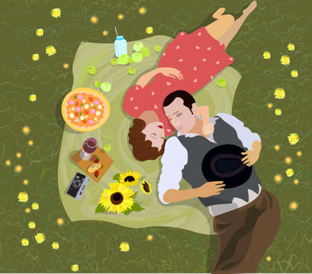 Two lovers are laying on grass, enjoying their picnic date on a summer day.の写真素材