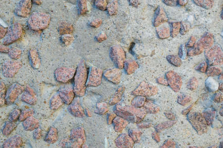 the texture of the stone in plaster red stones on a white backgroundの写真素材