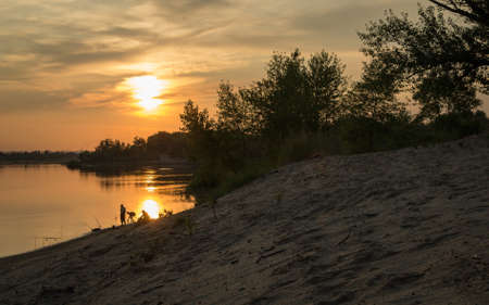 silhouettes of fishermen summer vacation fishing hobby sportの写真素材