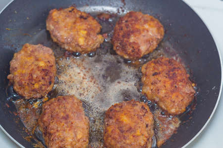 fried cutlets in a frying pan cooking