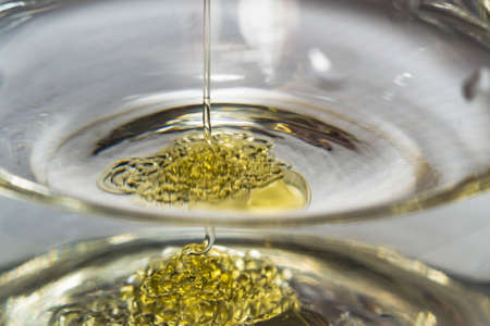 honey in water macro photo close-up of a stream of honeyの写真素材
