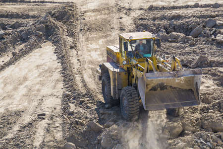 loader sand construction of high-rise building spring day
