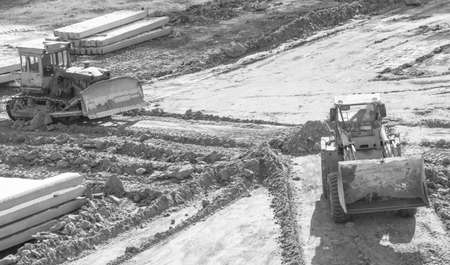 loader sand construction of high-rise building spring day