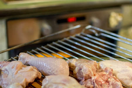 grilled chicken cooking with potatoes in the ovenの写真素材