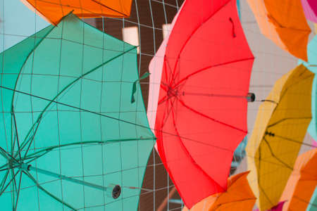 multicolored umbrellas at the top look up in the airの写真素材