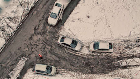 view from the balcony on top of people and cars spring in Siberiaの写真素材