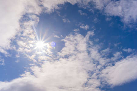Sun in the blue sky with clouds spring