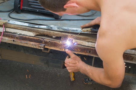 fixing a car worker welding welding work in the summer