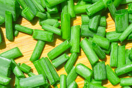green onions texture macro photo on the Board to cut the onionの写真素材