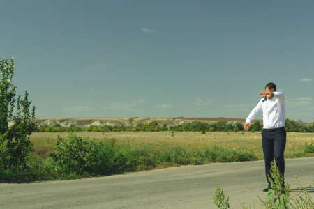businessman walking on the road in white shirt and trousersの写真素材