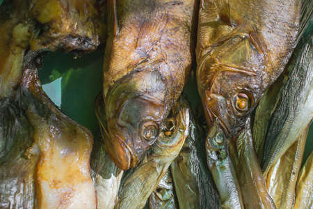 cold smoked fish on wooden background in rustic style