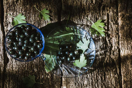 Fresh ripe blackcurrants on rustic woodの写真素材