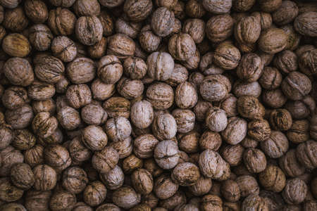 Background of walnuts vintage texture of fresh ripe nutsの写真素材