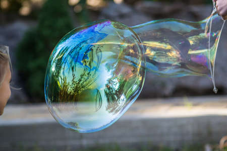 big soap bubbles on nature background fun for kidsの写真素材