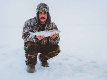 fisherman on white background concept winter fishing catch fish omul