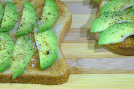 toast with avocado slices on wooden background vegetarian healthy food