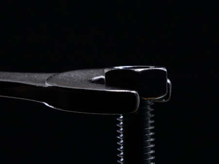 construction tools on black background. the concept of building renovations. Adjustable wrench and screwsの写真素材